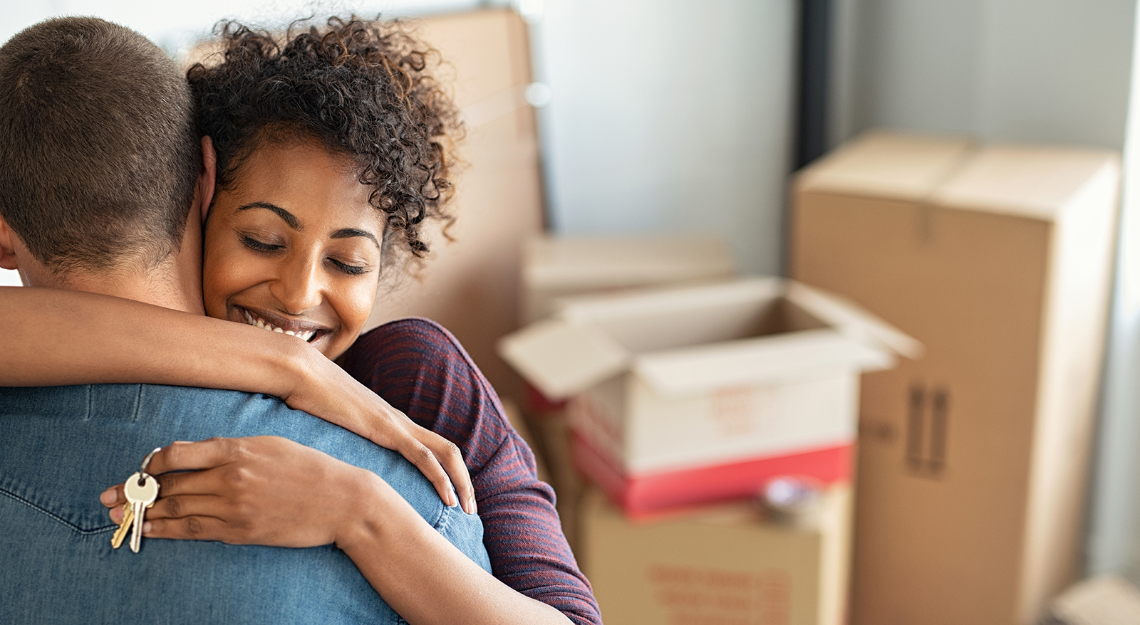 woman hugging man holding keys